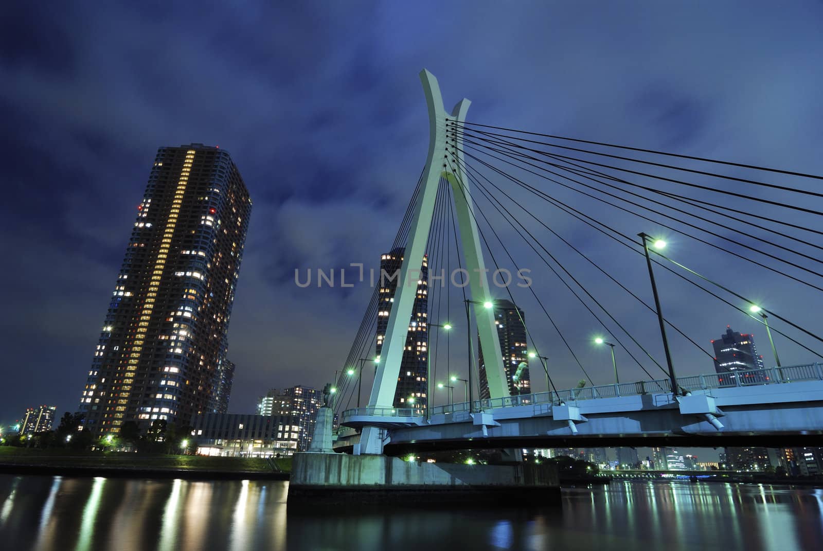 modern Chuo-Ohashi bridge in Tokyo over Sumida river waters by night