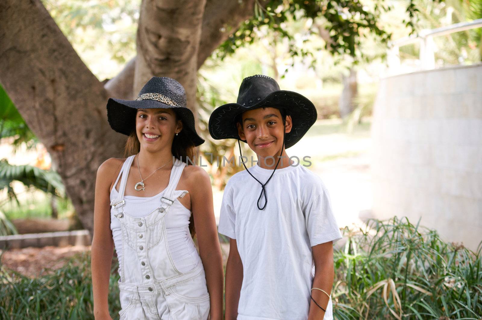 Boy and girl walking through the park.