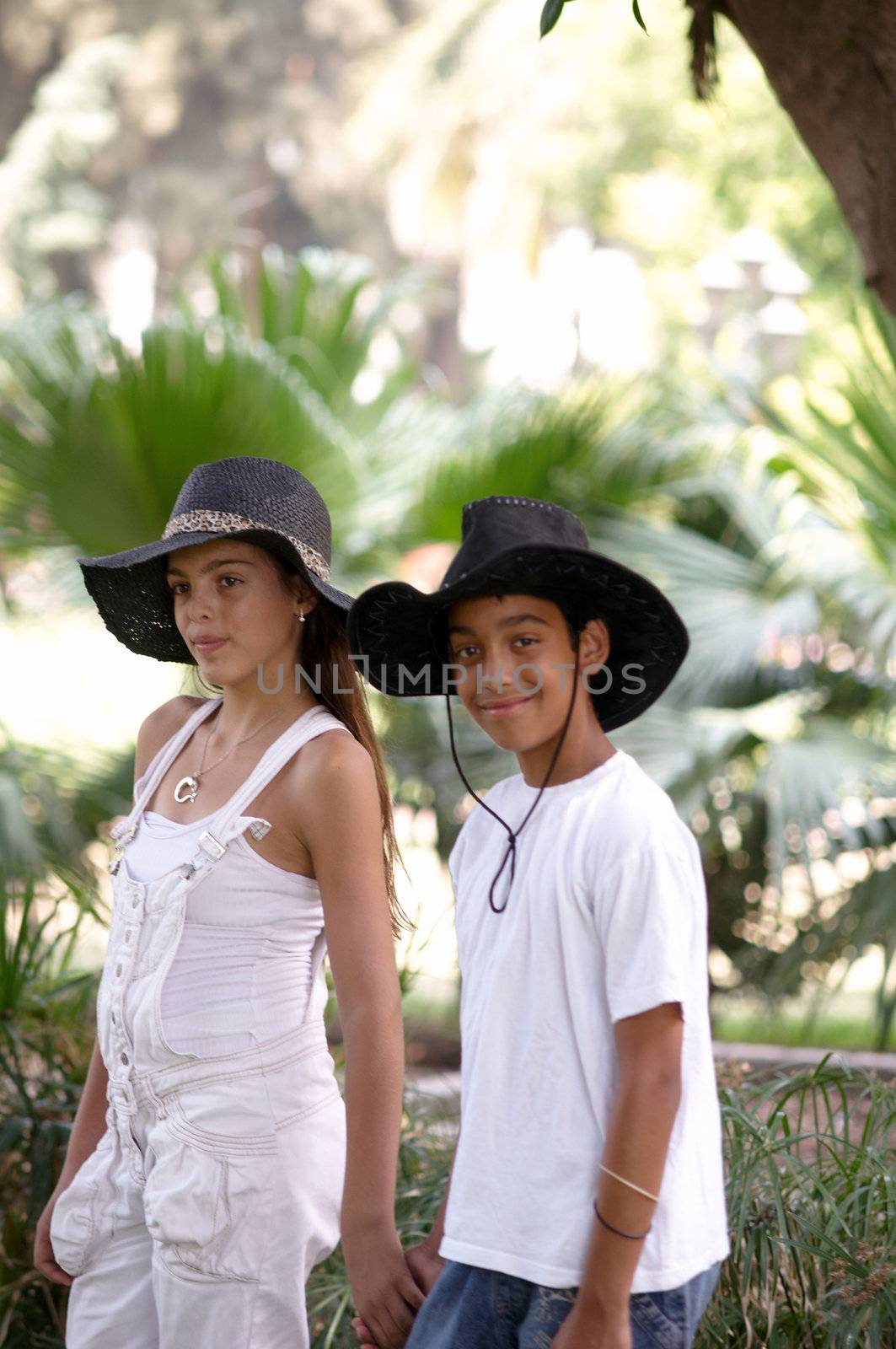 Boy and girl walking through the park.