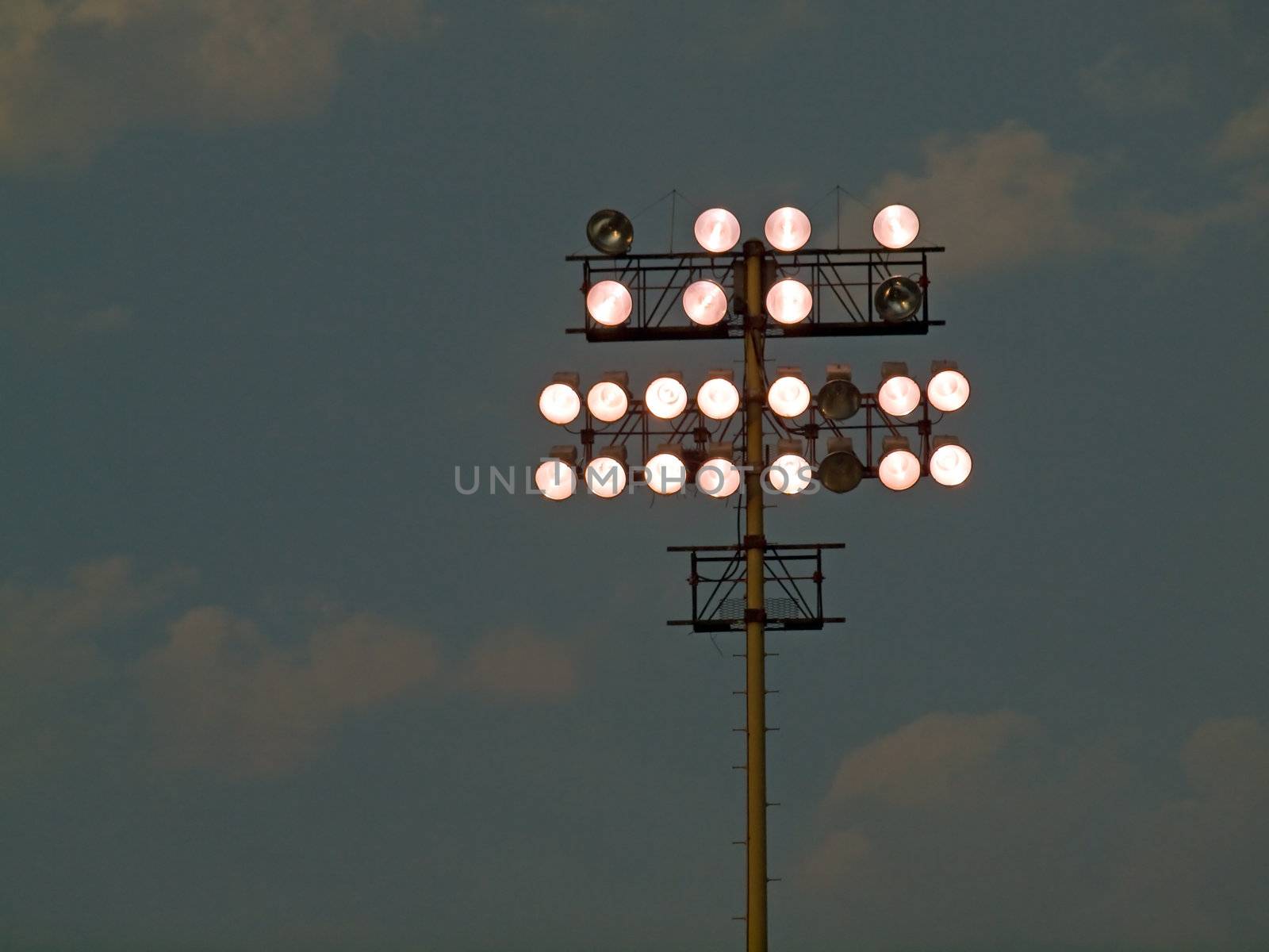 Stadium Lights Against an Evening Sky at Dusk by Frankljunior