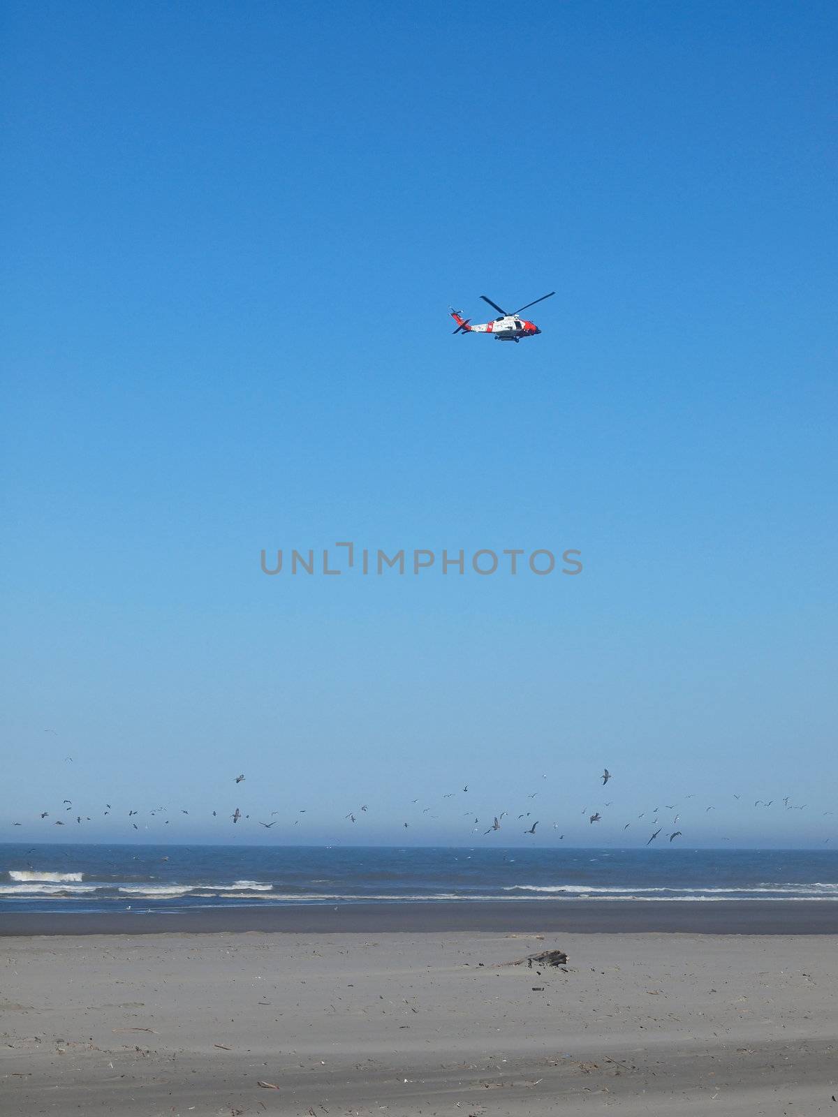 A Coast Guard Helicopter Patrolling the Shoreline on a Clear Day