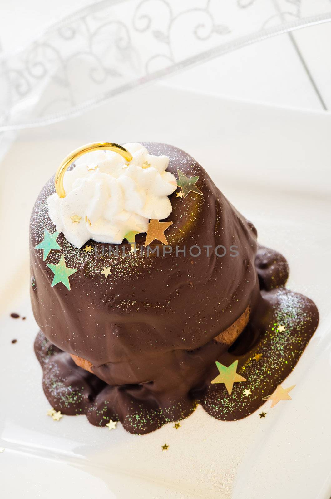 Christmas cupcake as a bell with decoration on white wooden table