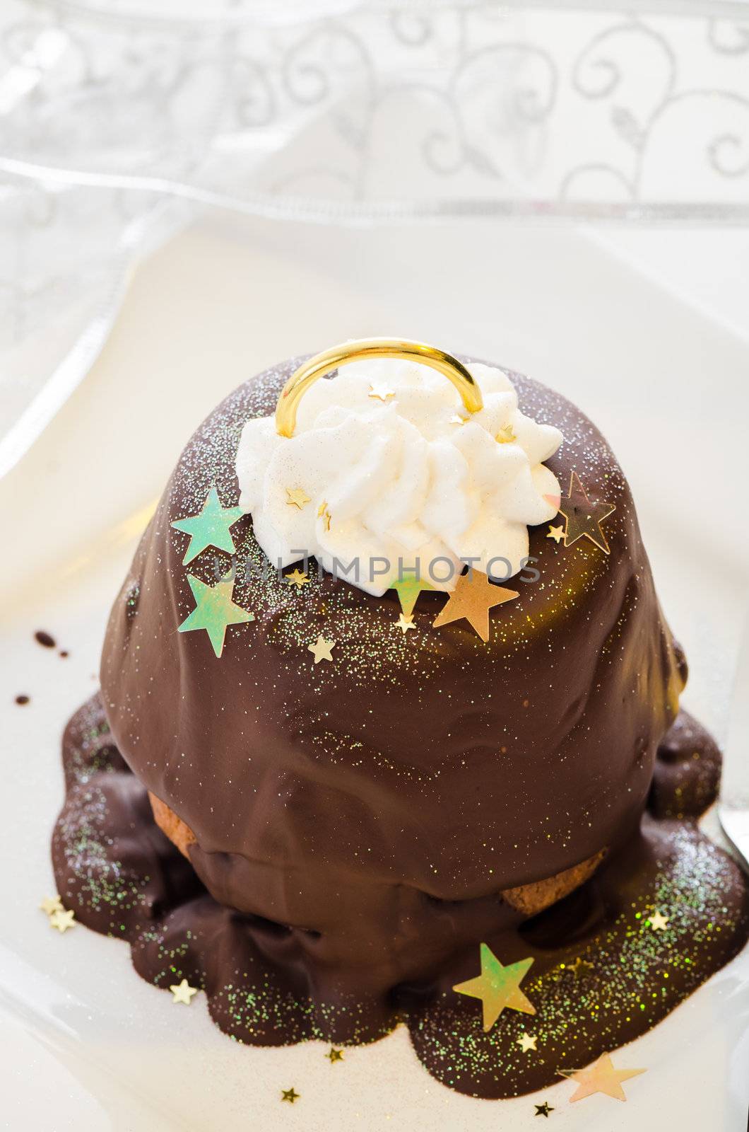 Christmas cupcake as a bell with decoration on white wooden table