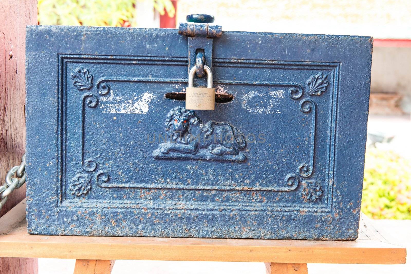 Old vintage metal box with pad lock, made from blue steel with lion carving symbol