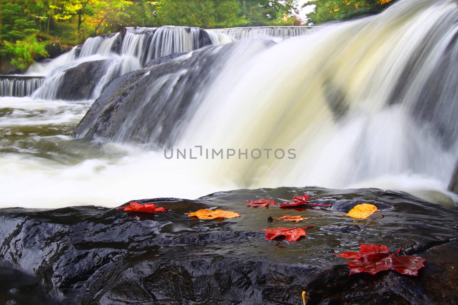 Autumn foliage surrounds the cascading waters of Bond Falls in northern Michigan.