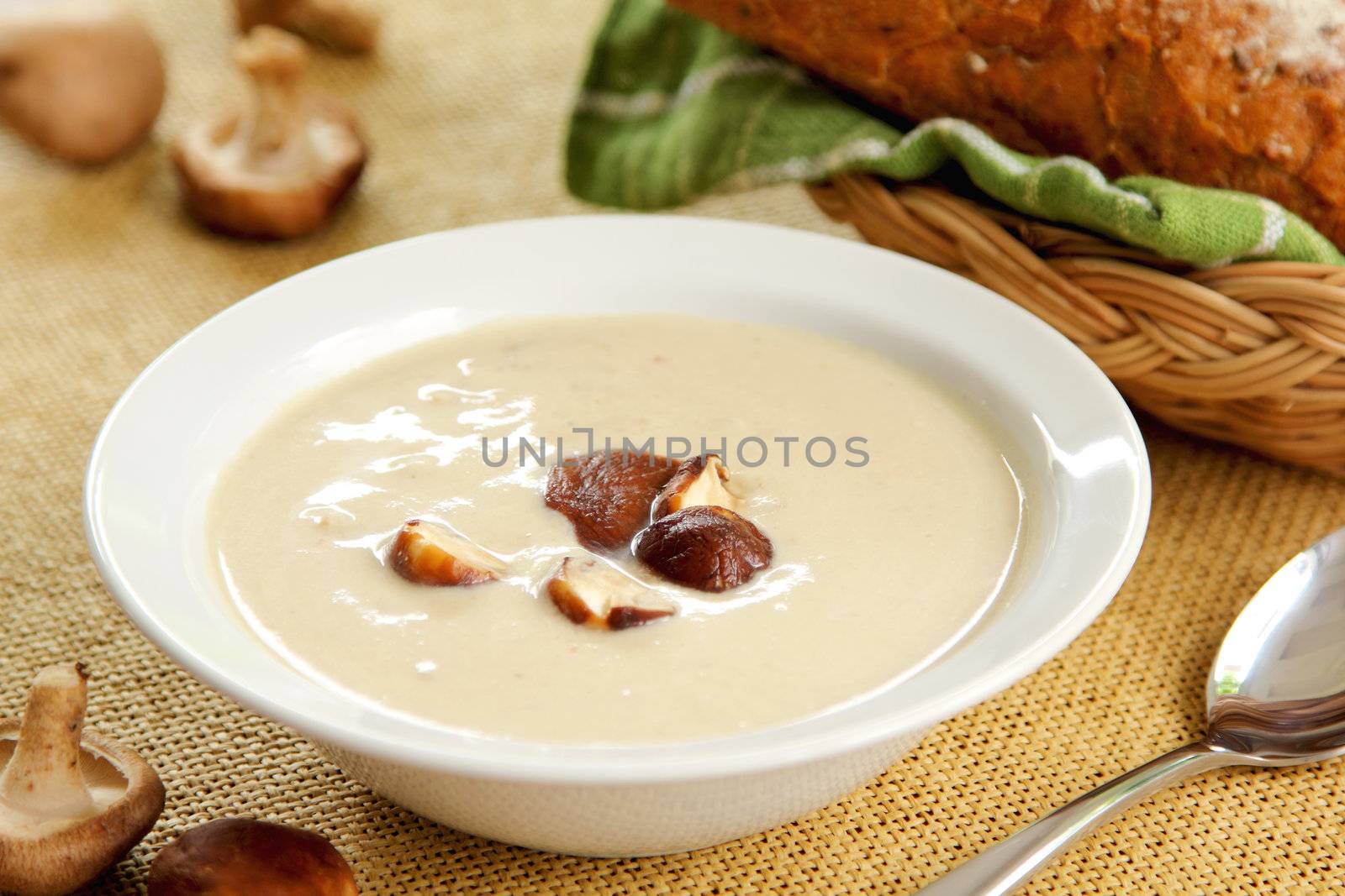 Mushroom soup by loaf of wholemeal bread