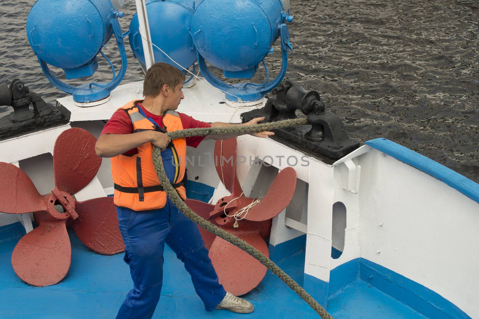 The ship worker prepares a vessel for departure. Taken in Russia, Volga river on July 2012.