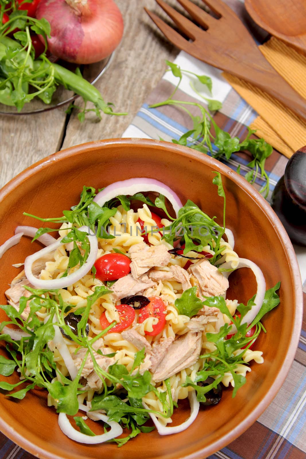 Fusilli with Tuna and olive salad in wood bowl