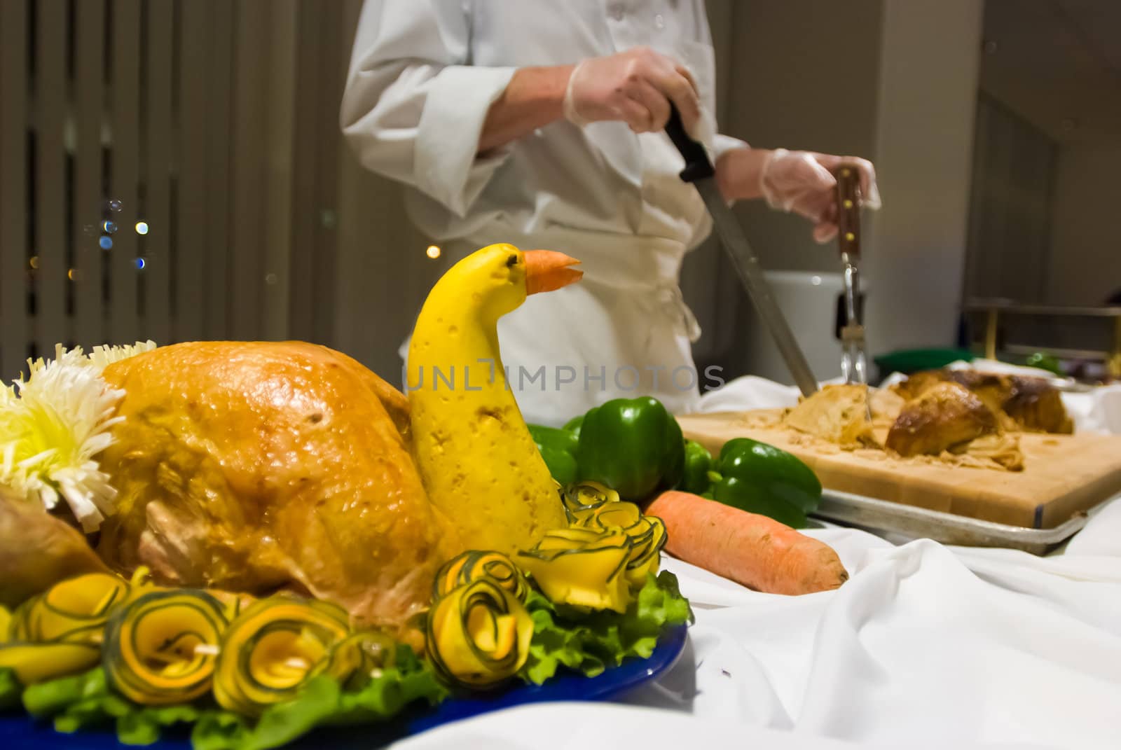 Server preparing to cut turkey at a buffet