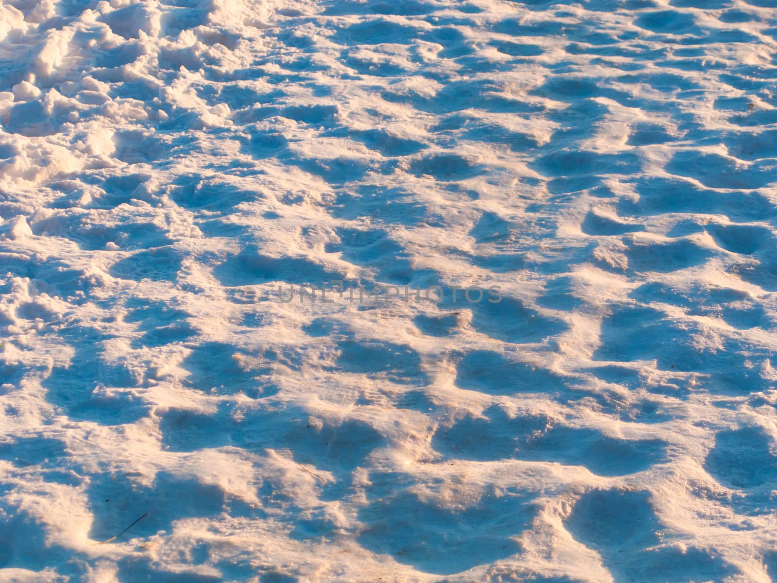 Footprints worn into the snow on a winter day