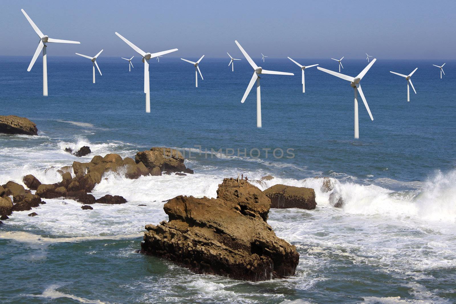 several offshore wind line on the horizon on cloudy sky background