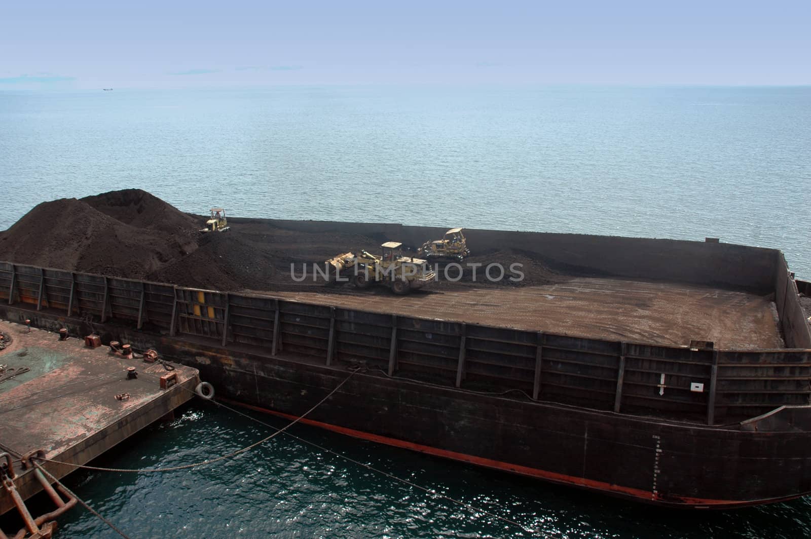 large pontoon boats transporting coal by antonihalim