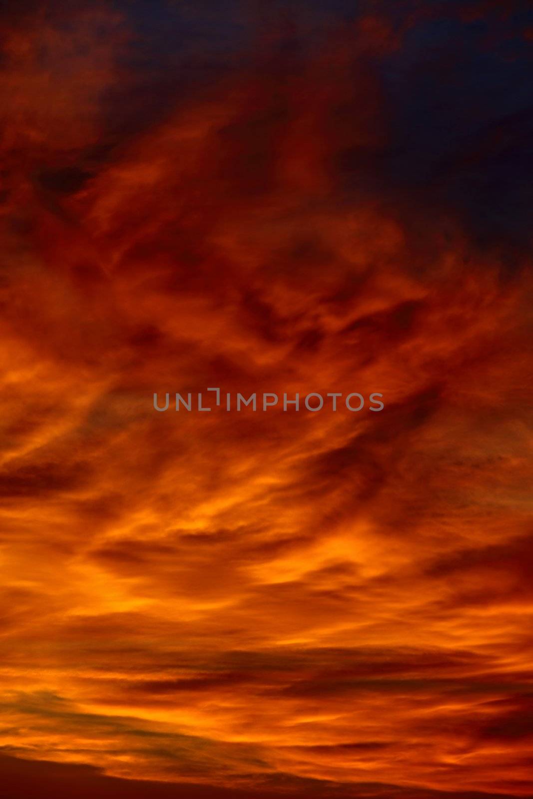 Dramatic sunset sky with clouds glowing red