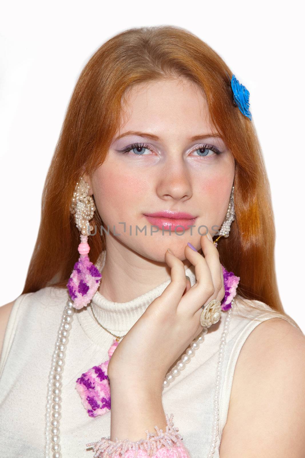 Redhead girl showing jewelry. Portrait on white background