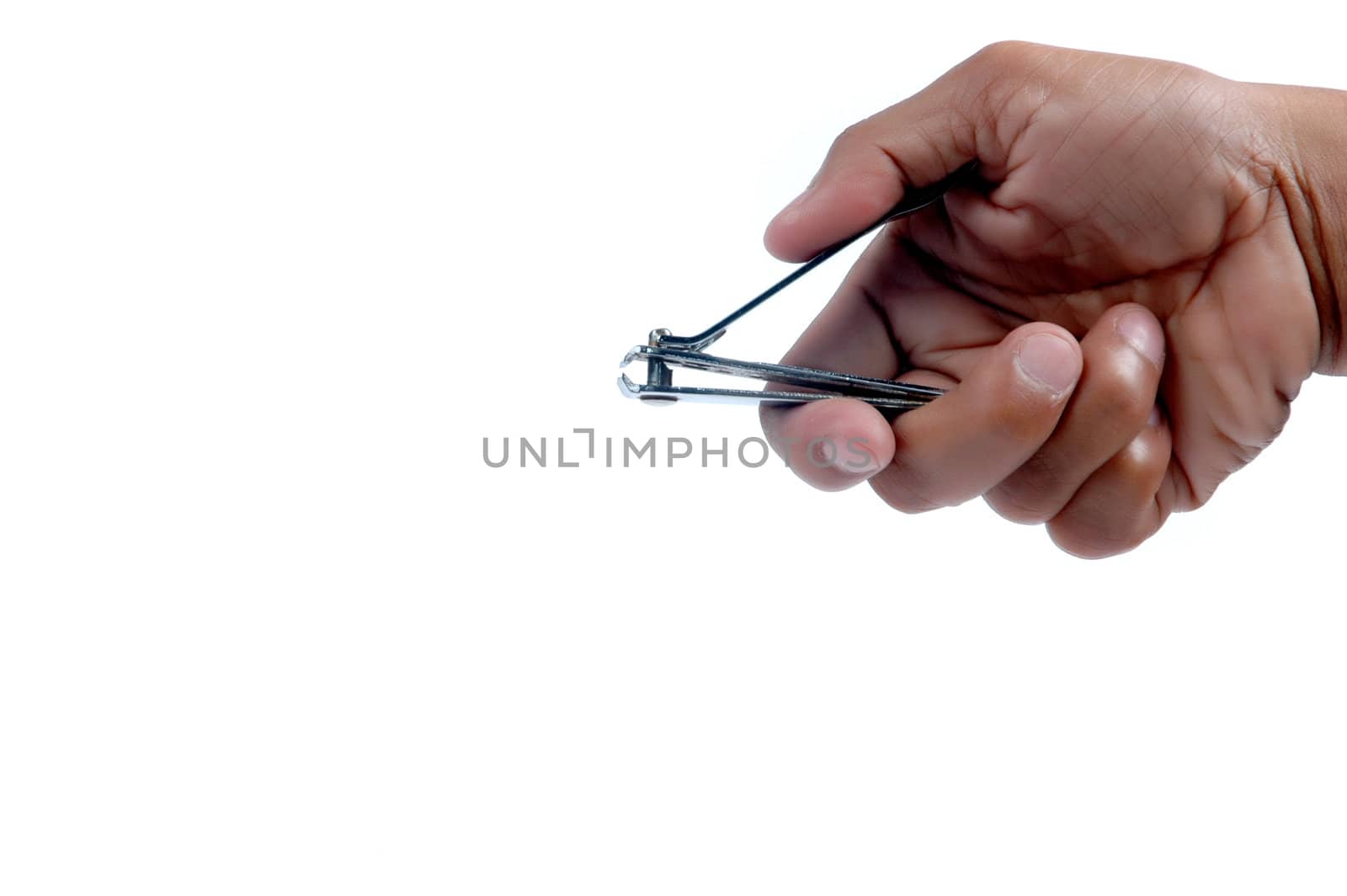 male hand holding a nail clippers  by antonihalim