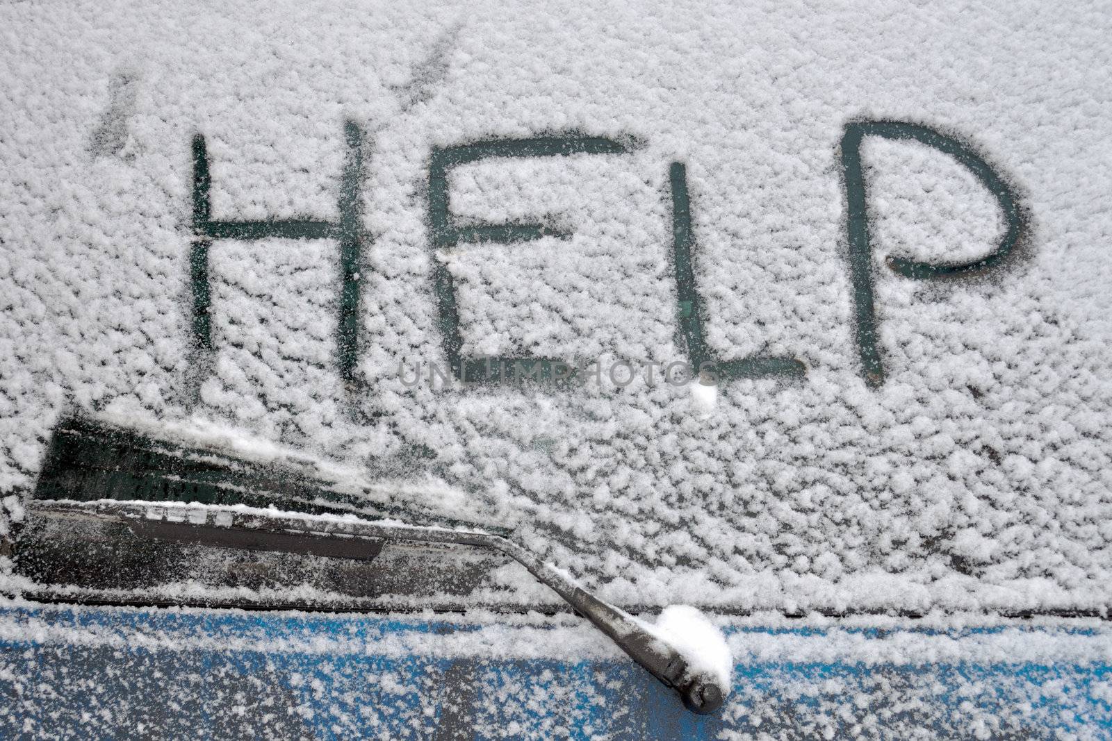 Help word written on rear car window covered by heavy snowfall
