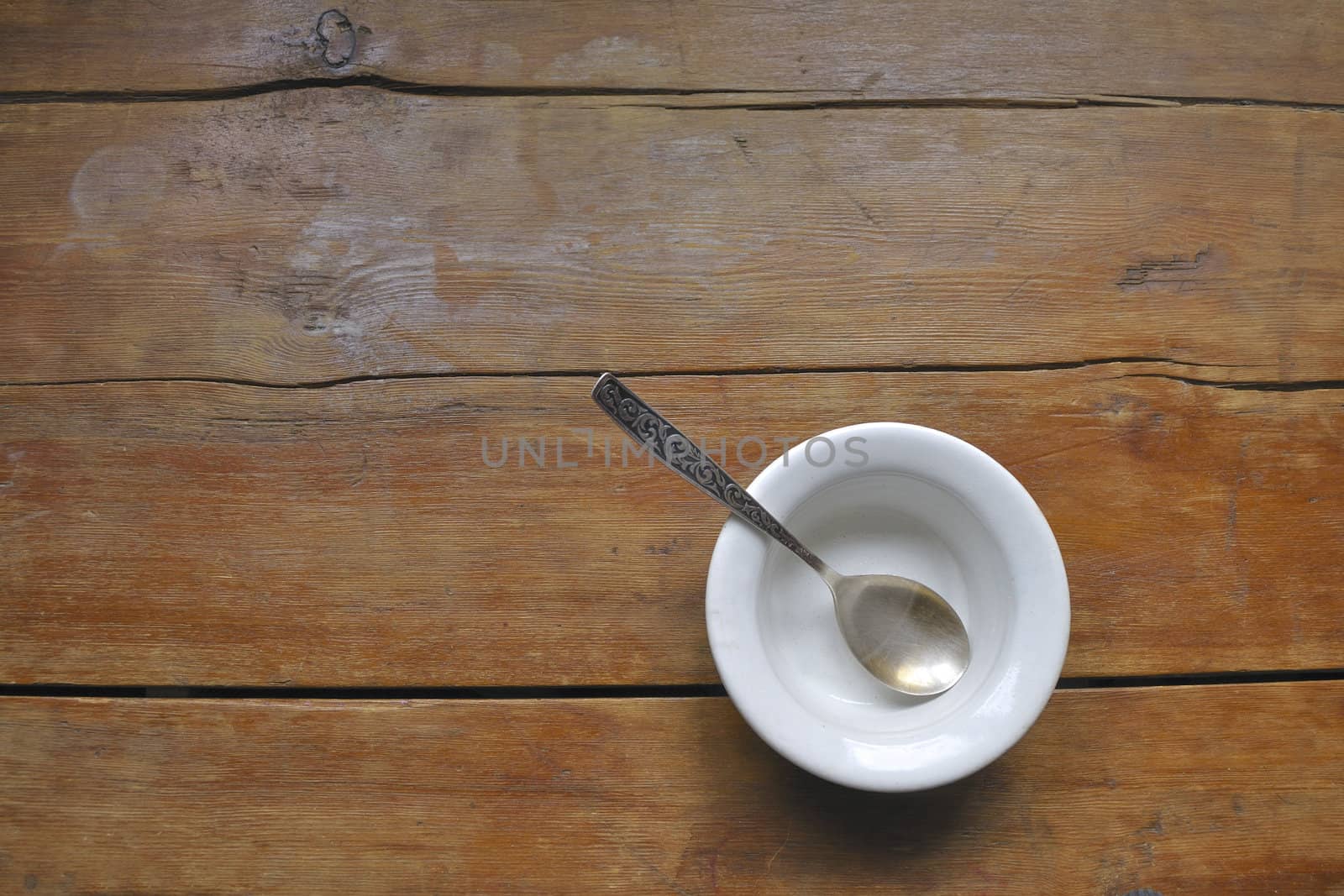vintage wooden kitchen table with empty soup bowl