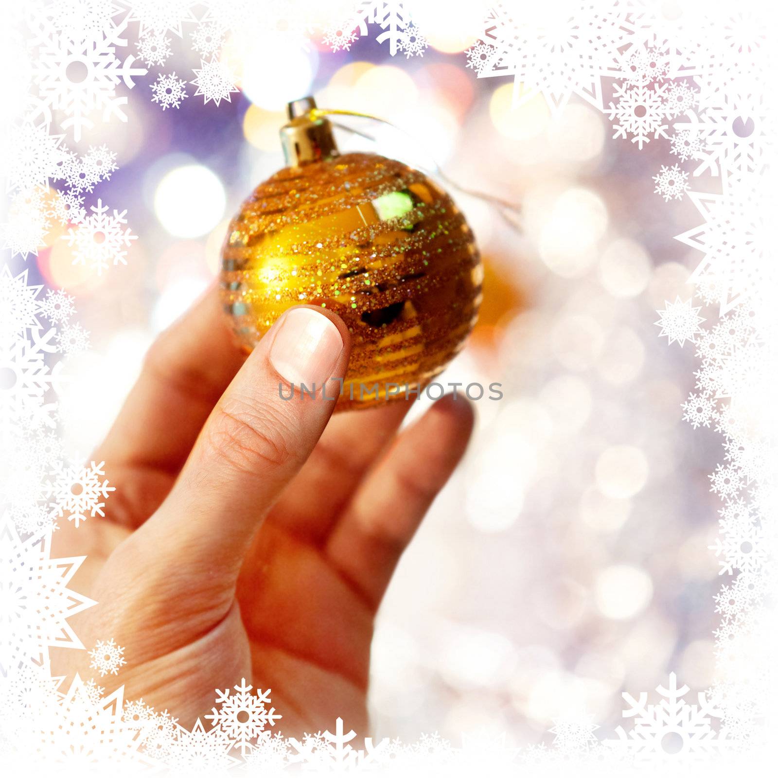 Christmas-tree decoration on hand, shiny background