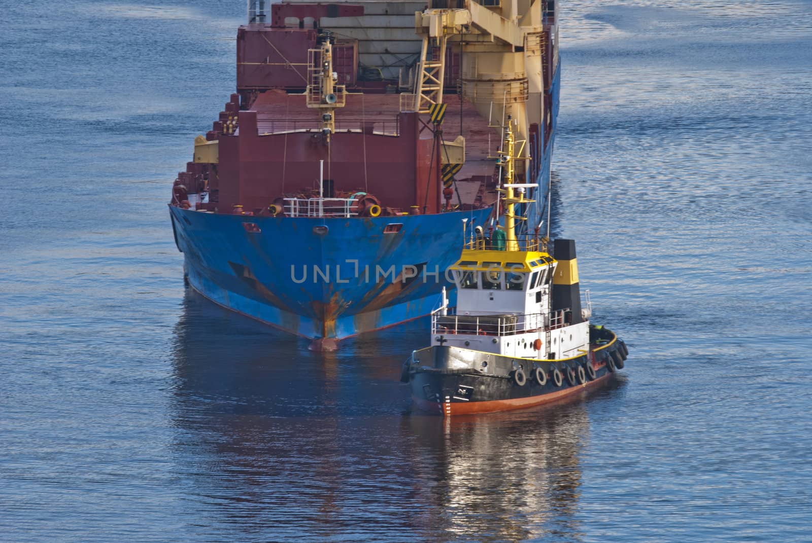 tug herbert moving into ringdalsfjord to assist bbc europe out of the narrowest strait in the fjord, bbc europe is a big cargo ship