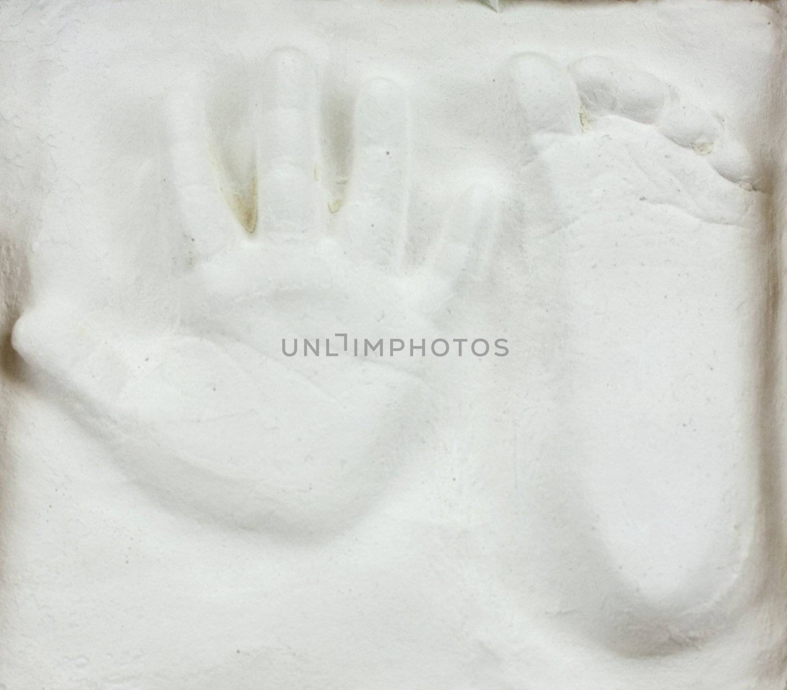 Little child's hand and foot print in gypsum