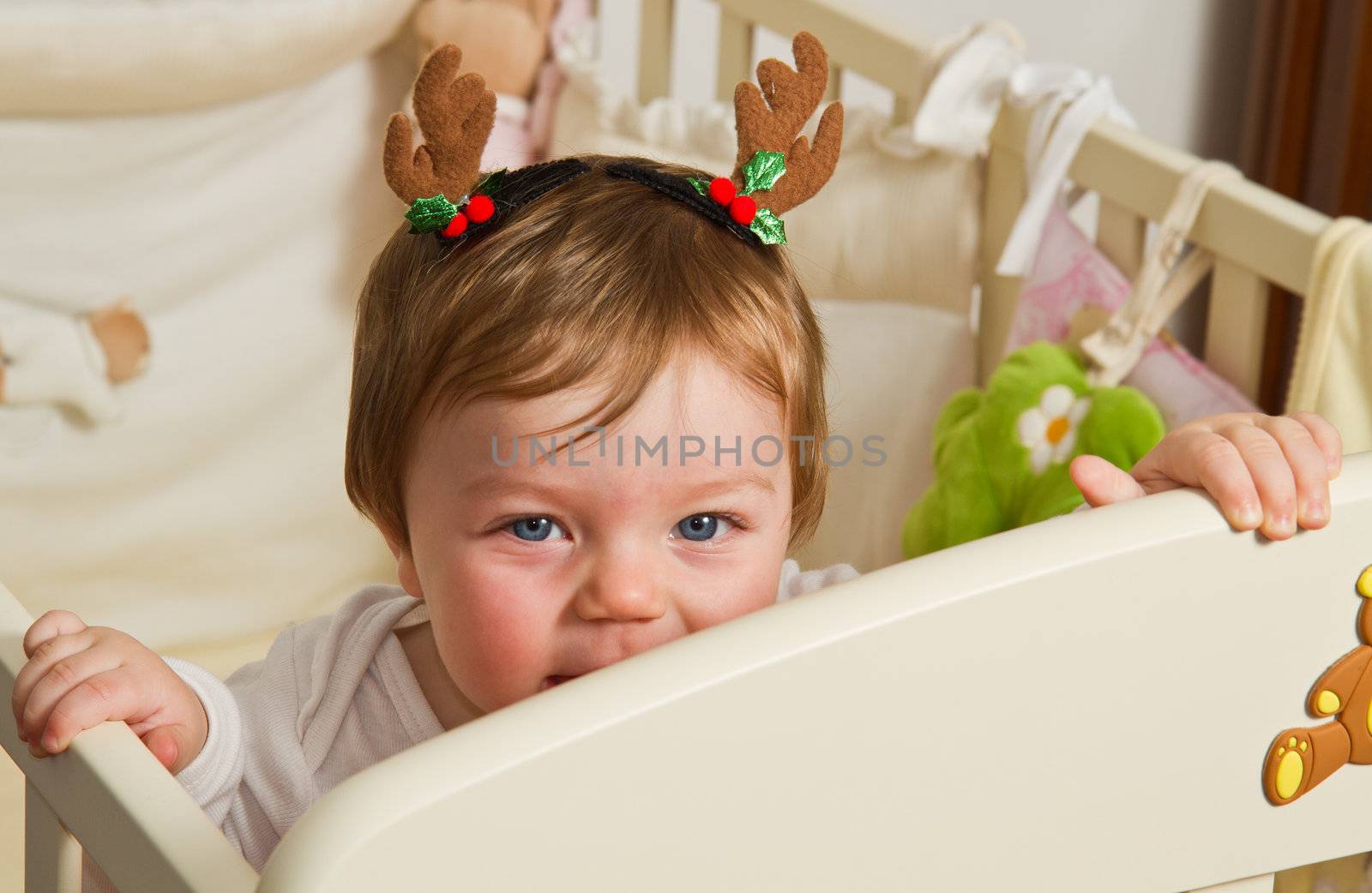 cute little baby with reindeer hat 
