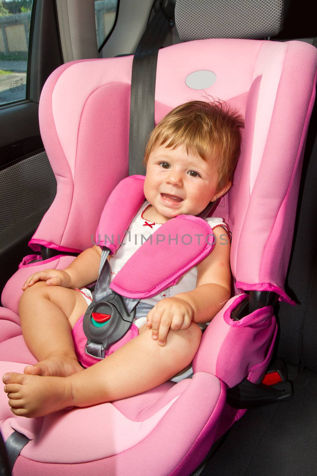 baby in a safety car seat. Safety and security by lsantilli