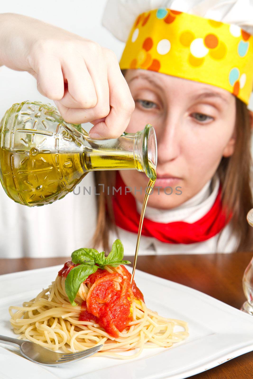  smiling chef garnish an Italian pasta dish 