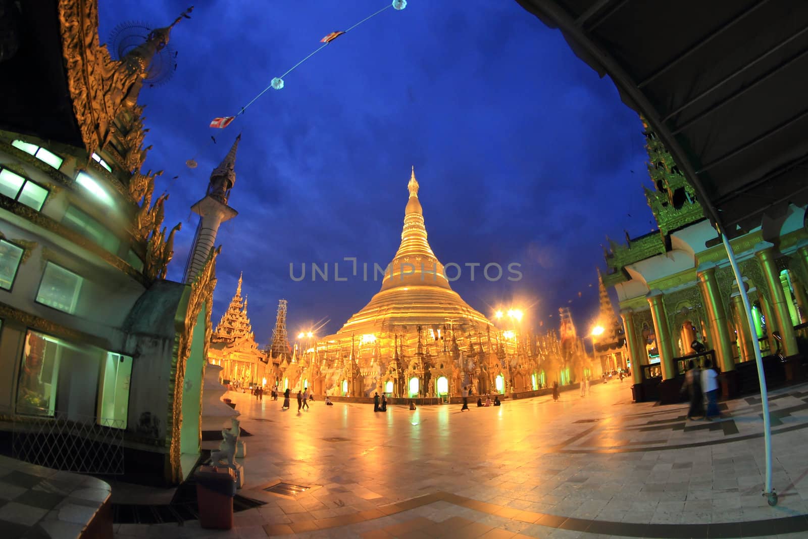 YANGON, MYANMAR - NOVEMBER 18: Buddhist devotees pray at the ful by rufous