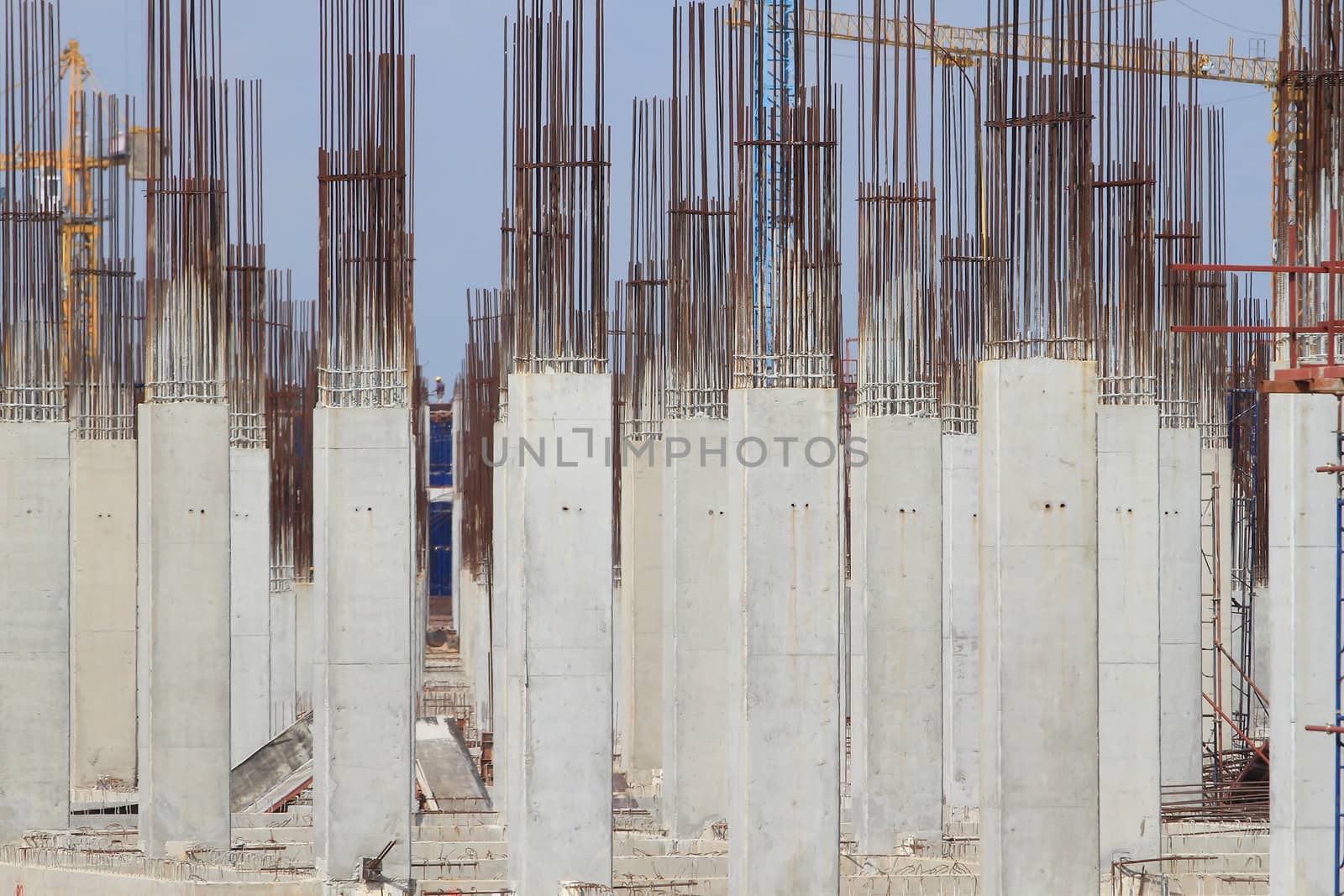 Construction site with enforced concrete steel frames rising up by rufous