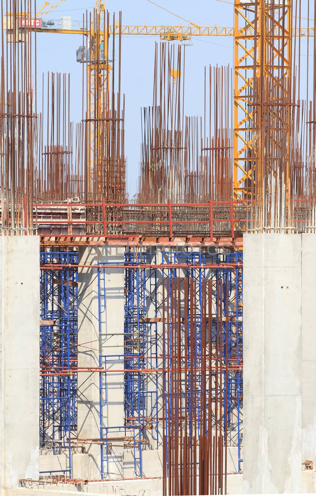 Construction site with enforced concrete steel frames rising up by rufous