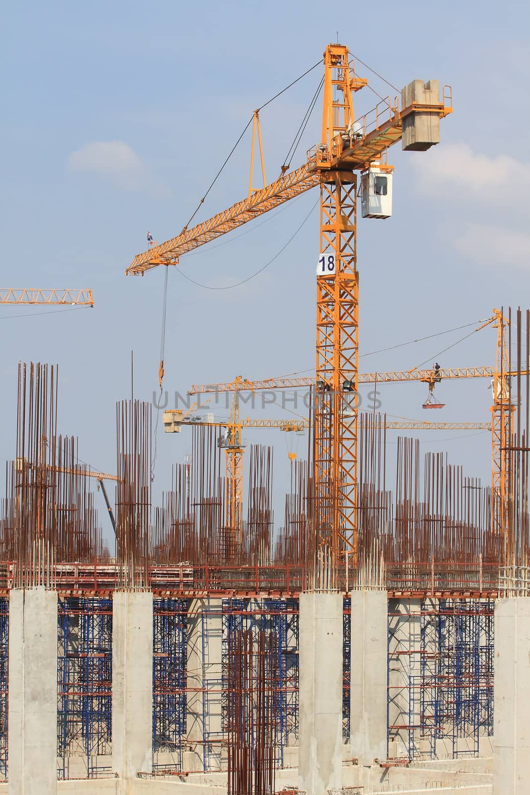 Construction site with enforced concrete steel frames rising up by rufous