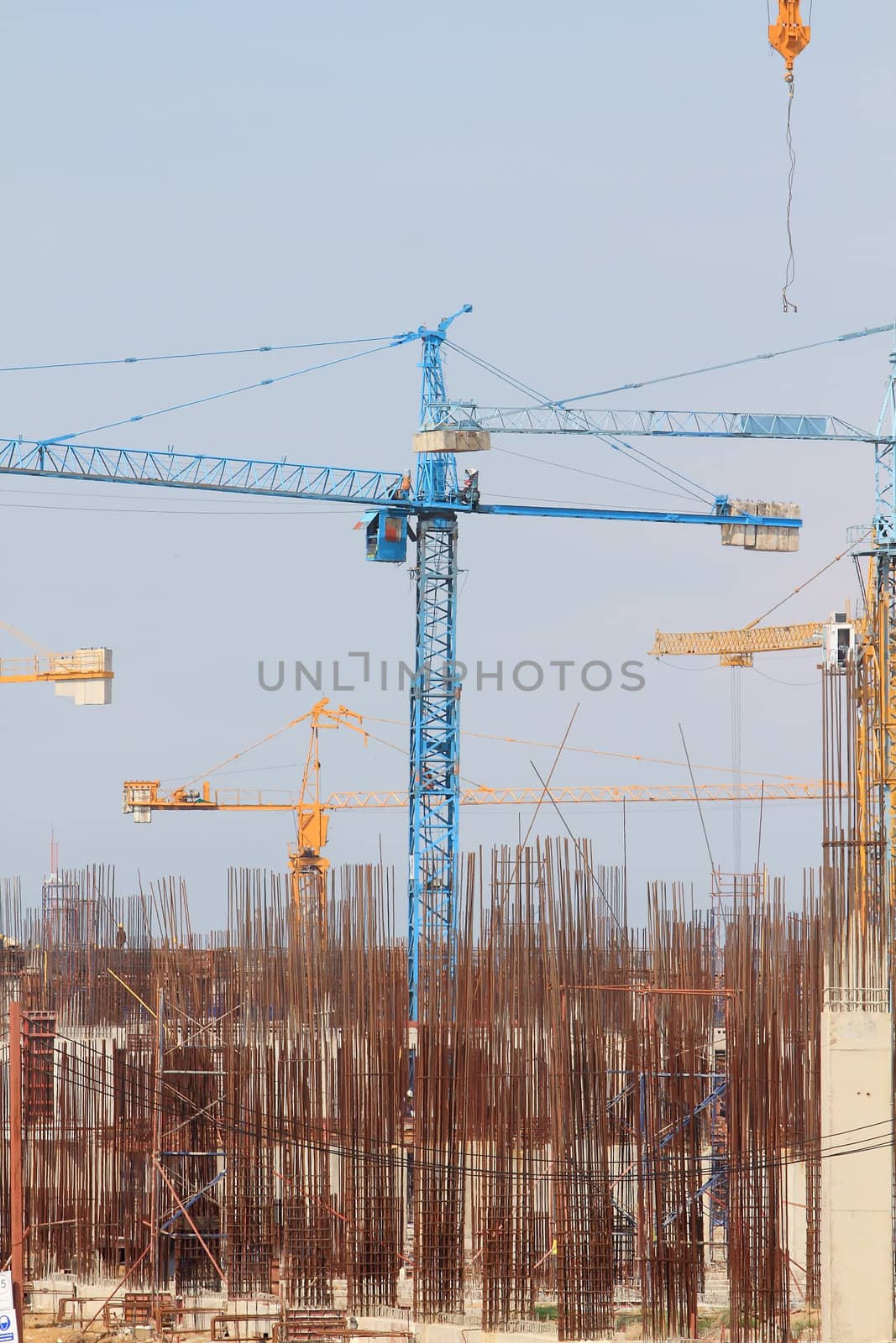 Construction site with enforced concrete steel frames rising up by rufous