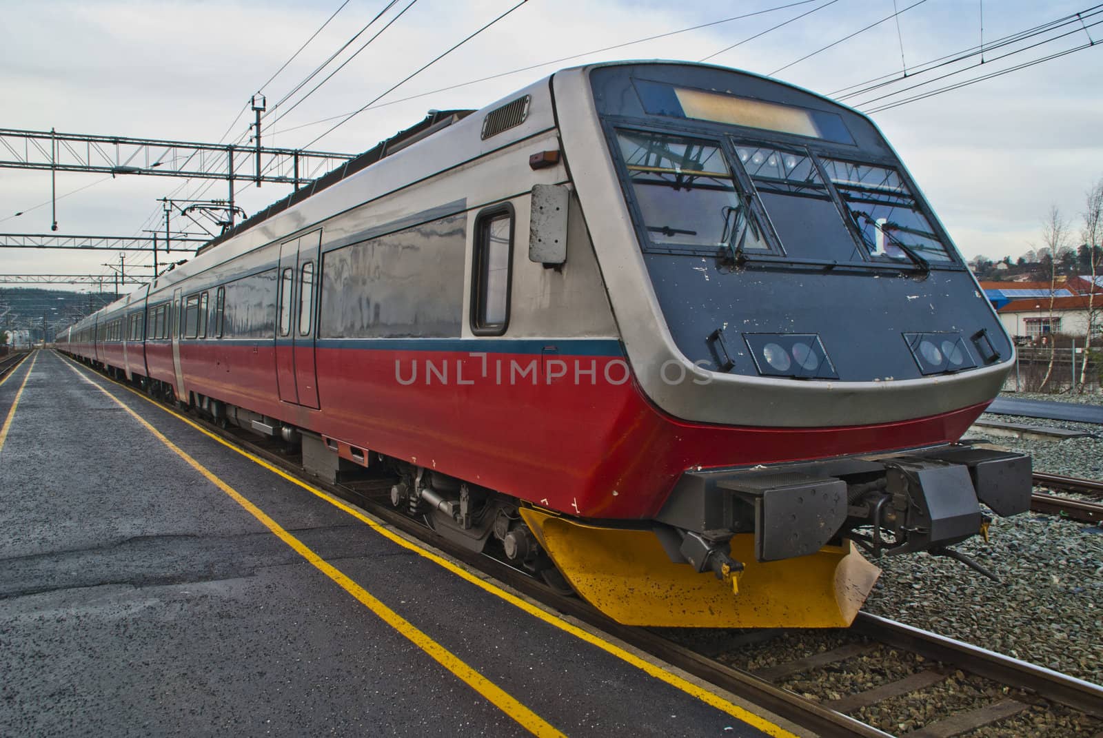 picture is shot in november 2012 at halden railroad station and shows nsb (in norwegian:  norges statsbaner) class 70 which is a four-carriage electric multiple unit, the train is used by nsb for medium distance trains around oslo, most in the dovre line between oslo and lillehammer / dombås and on the vestfold line