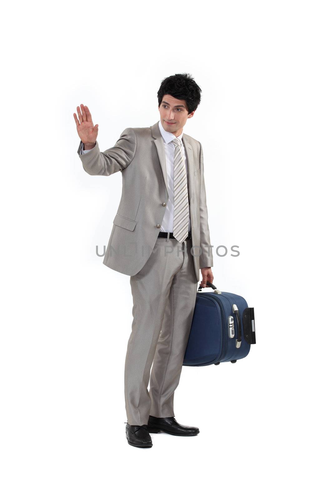 Man with suitcase waving goodbye