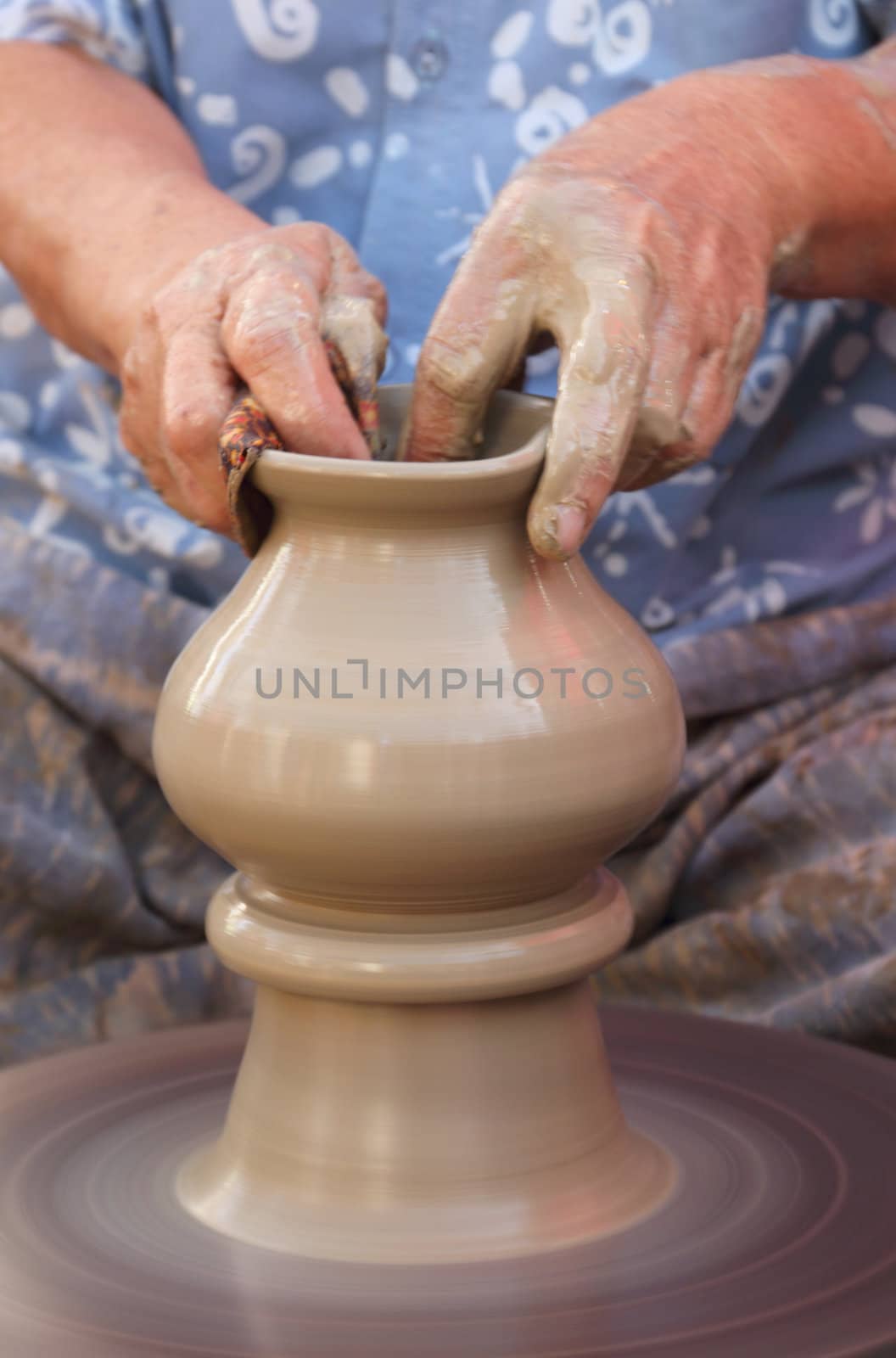 Old female hands making the traditional pottery