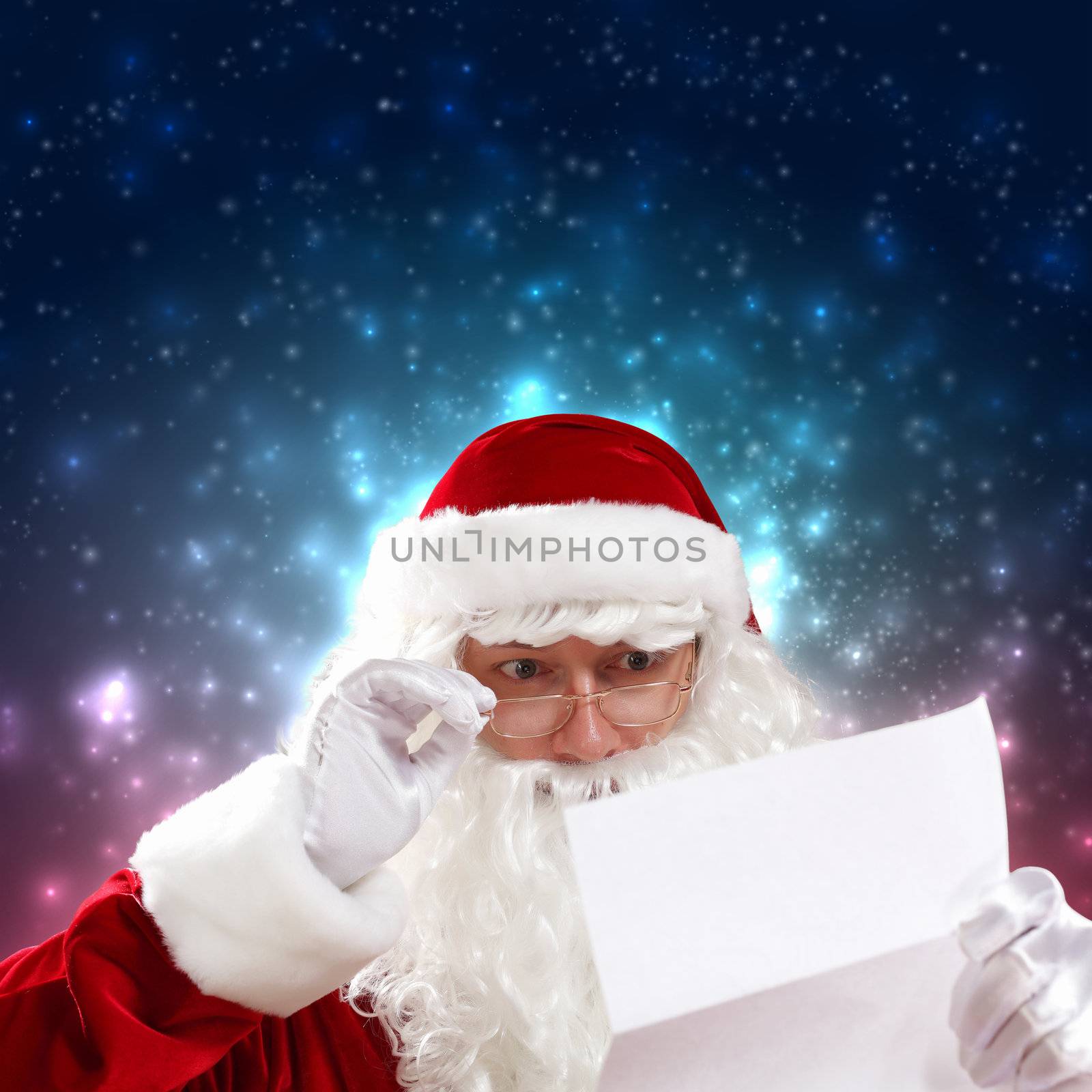 Santa holding Christmas letters and looking at camera