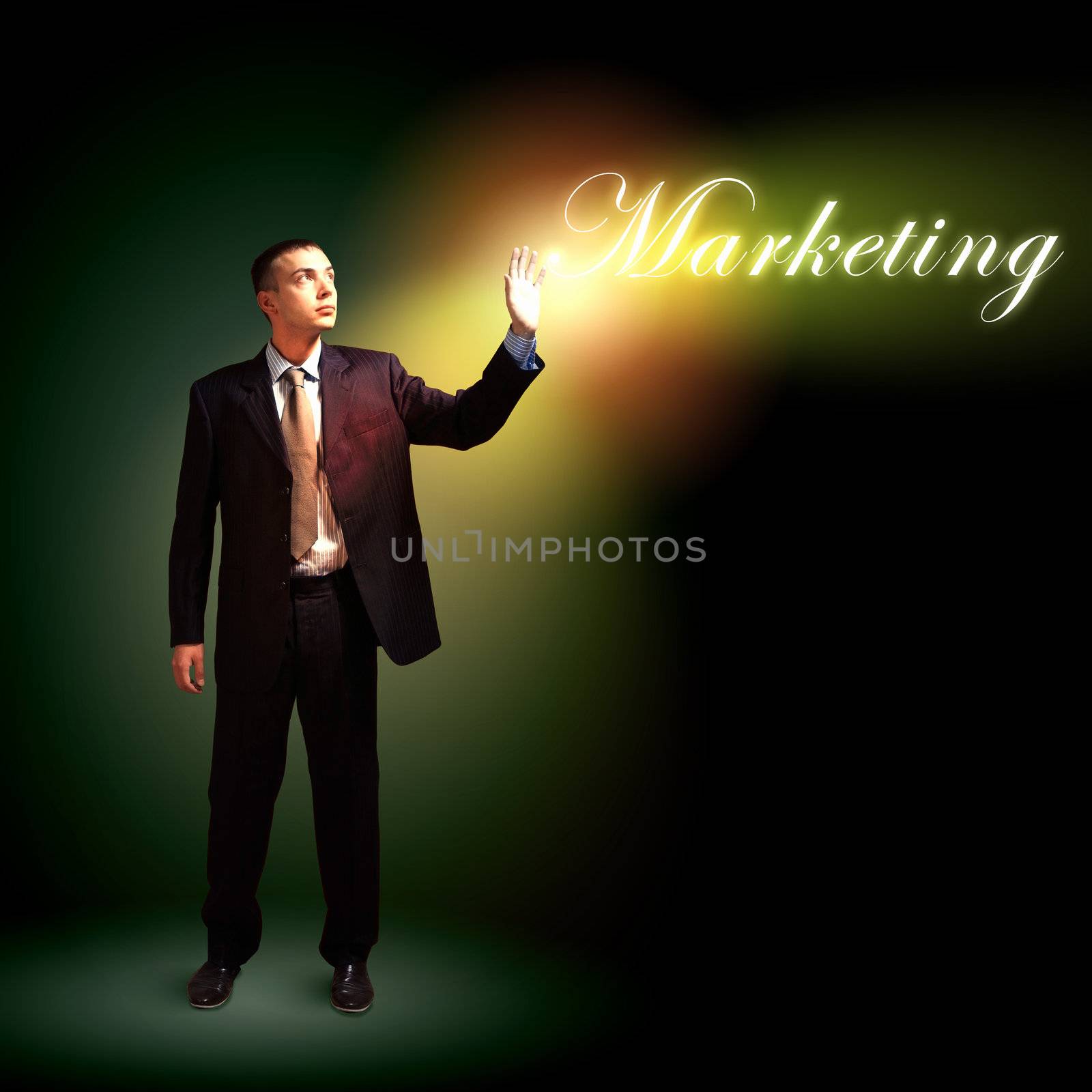 Young successful businessman holding a shining light in his hand as a symbol of success and advancement.