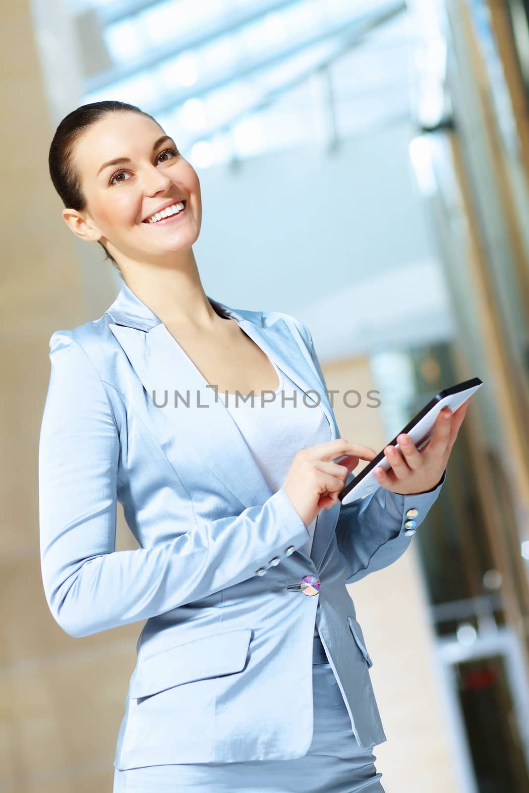 Portrait of happy smiling young businesswoman in office