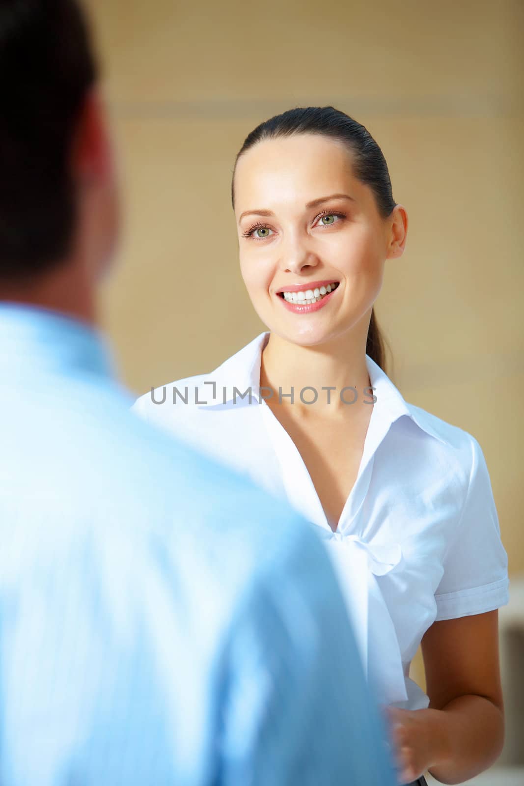 Portrait of happy smiling young businesswoman in office