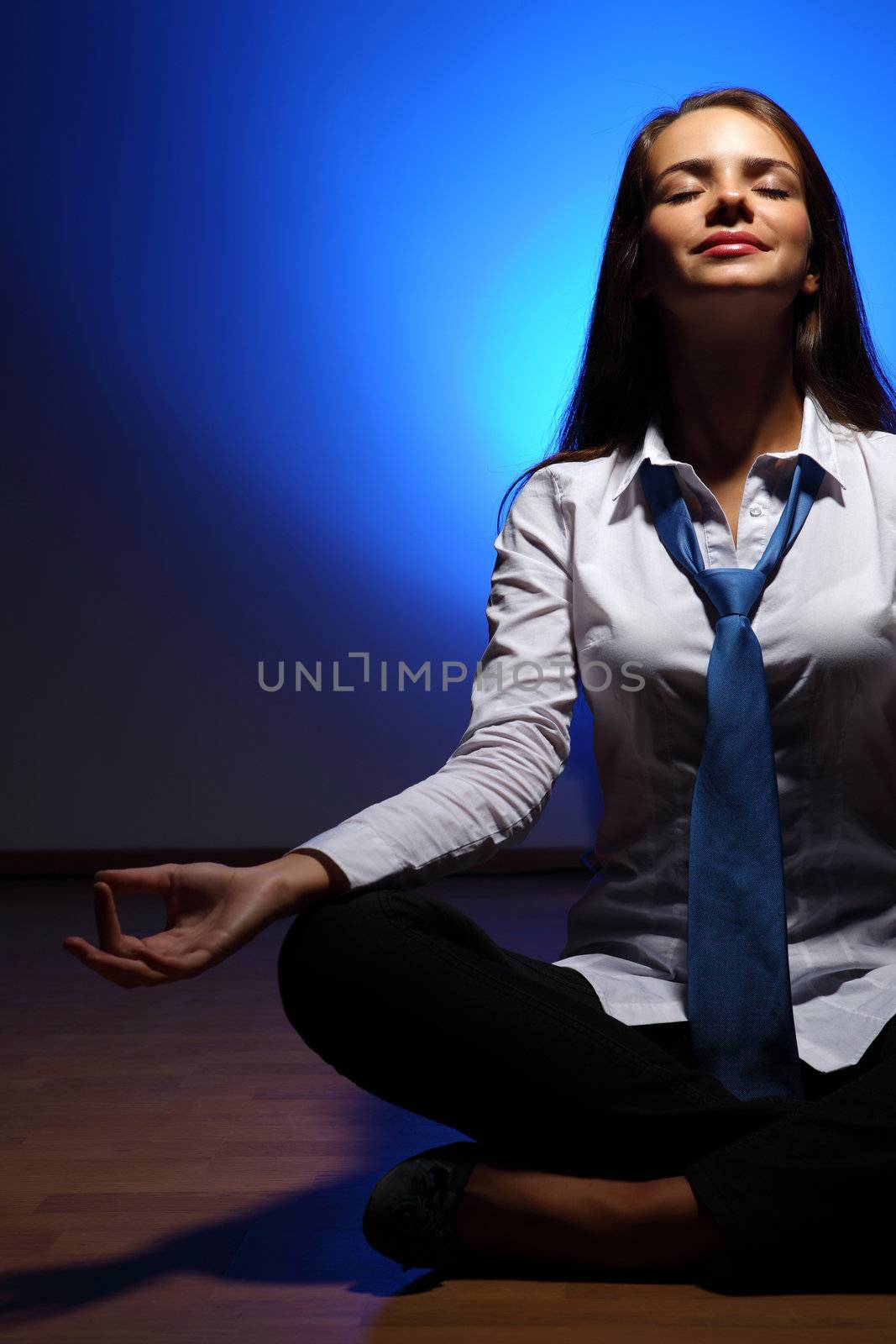 Young business woman sitting in asana lotus and meditating