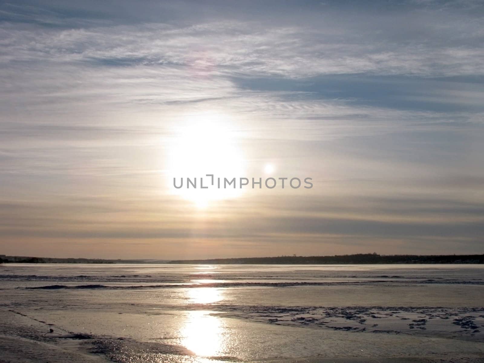 sun above frozen river
