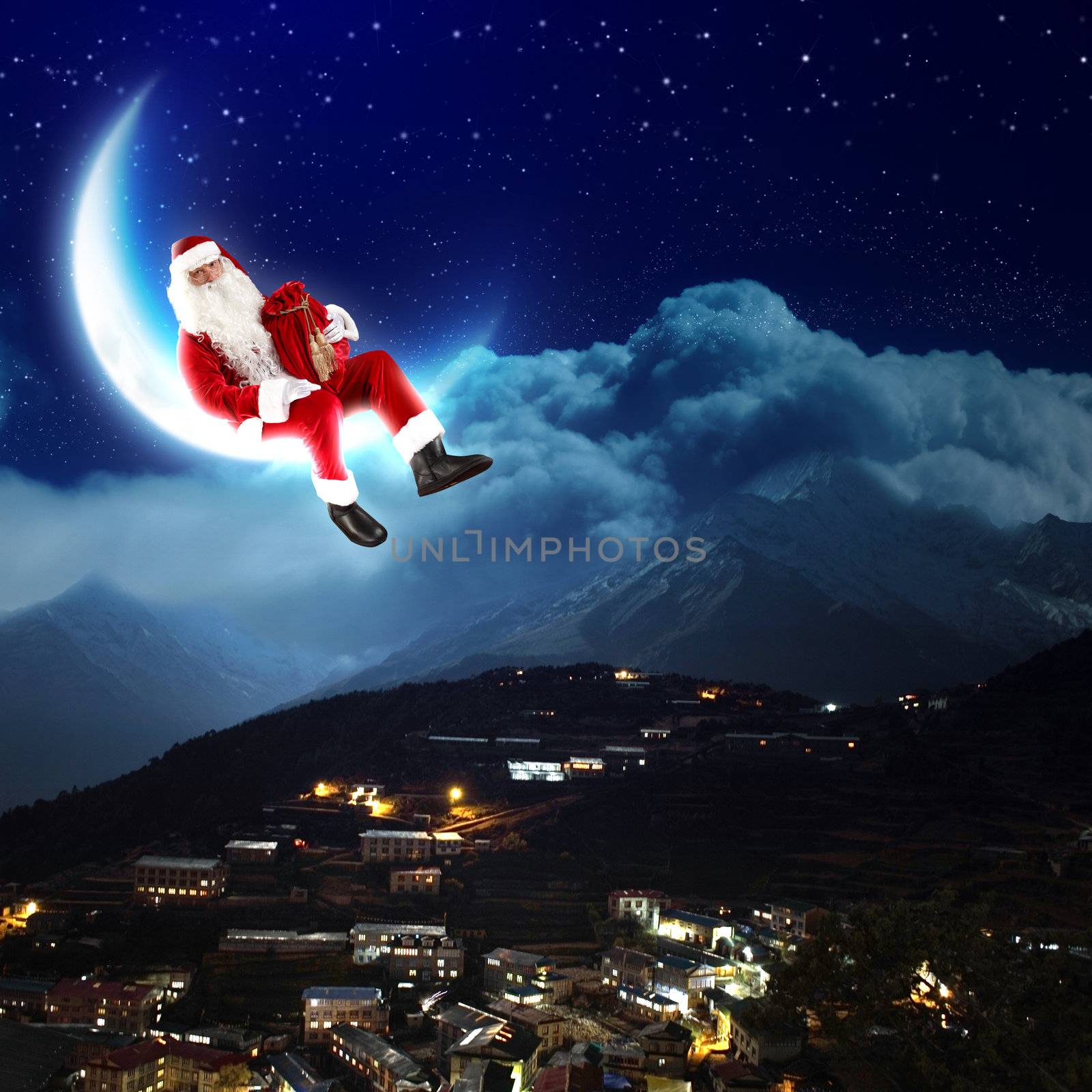 photo of santa claus sitting on the moon with a city and mountains below