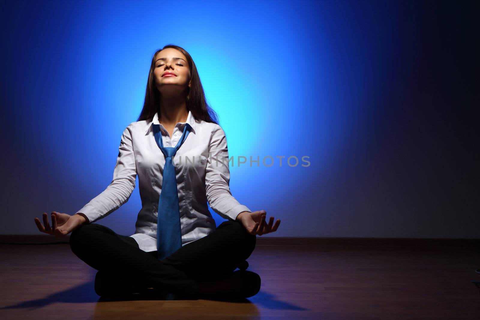 Young business woman sitting in asana lotus and meditating