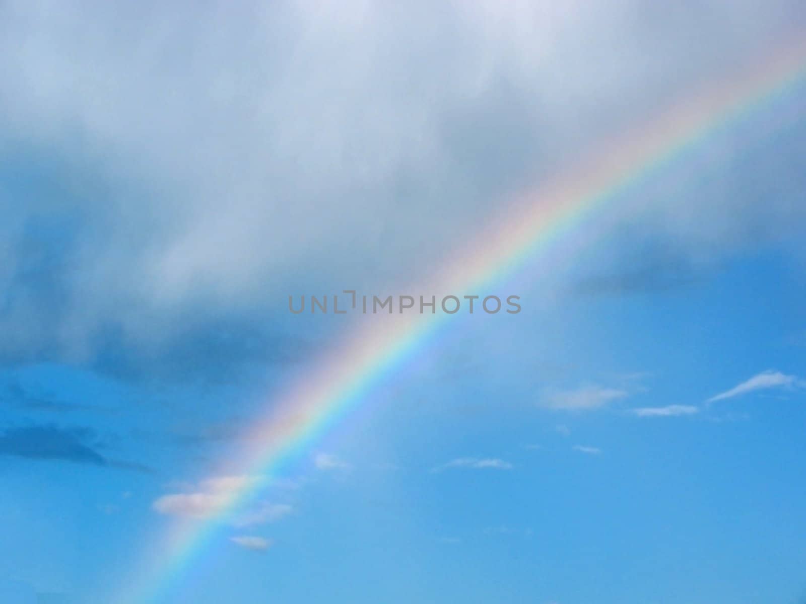 rainbow dividing clear and cloudy sky