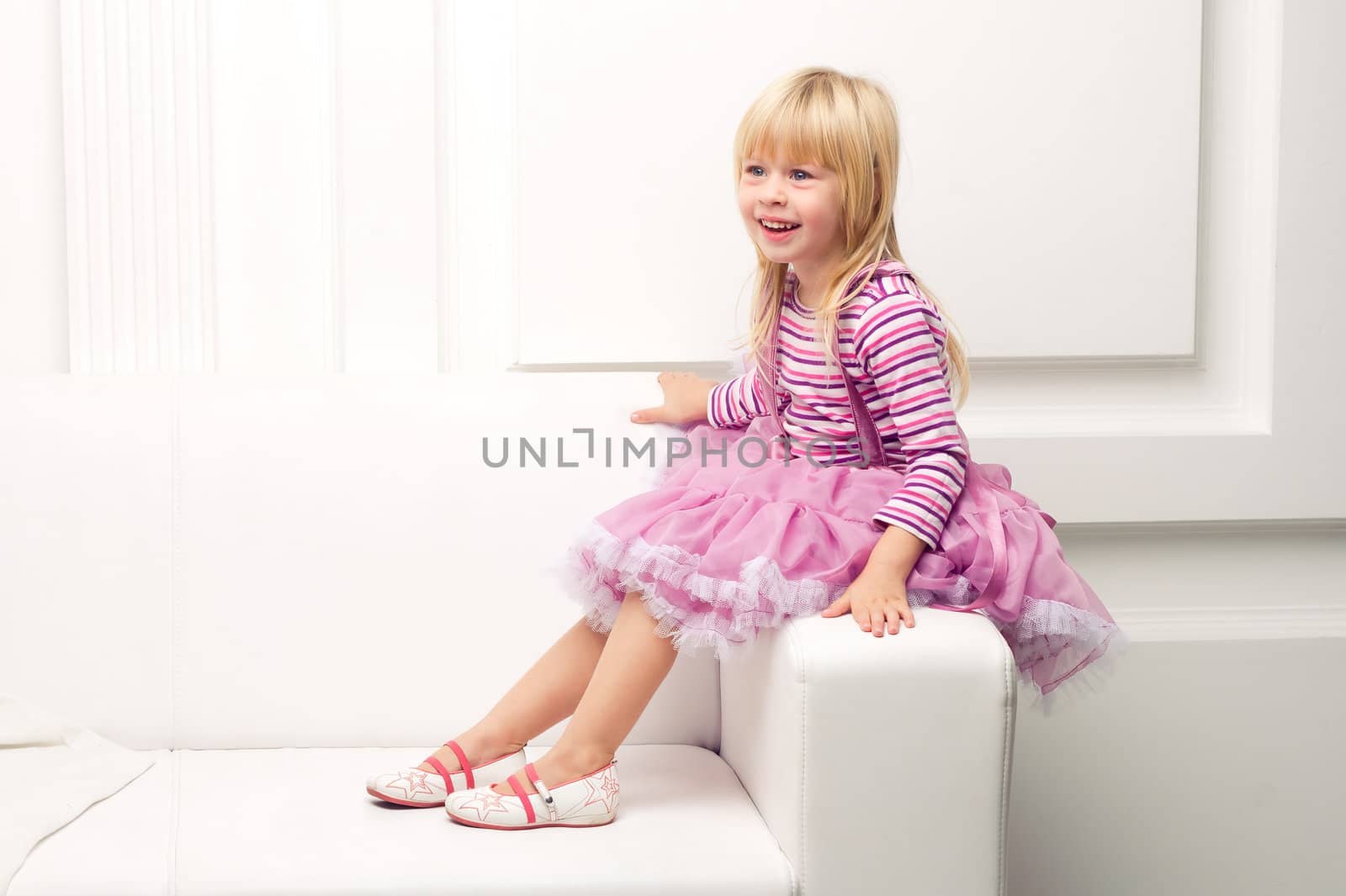 Little girl posing happily on sofa by victosha