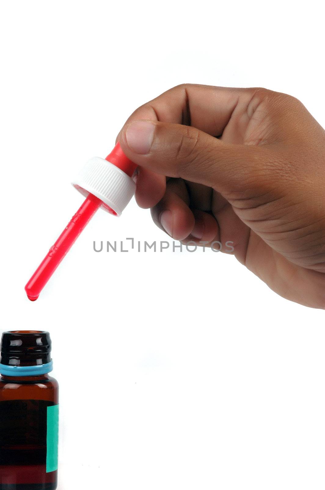 male hand holding a syrup medicine dropper isolated on white background