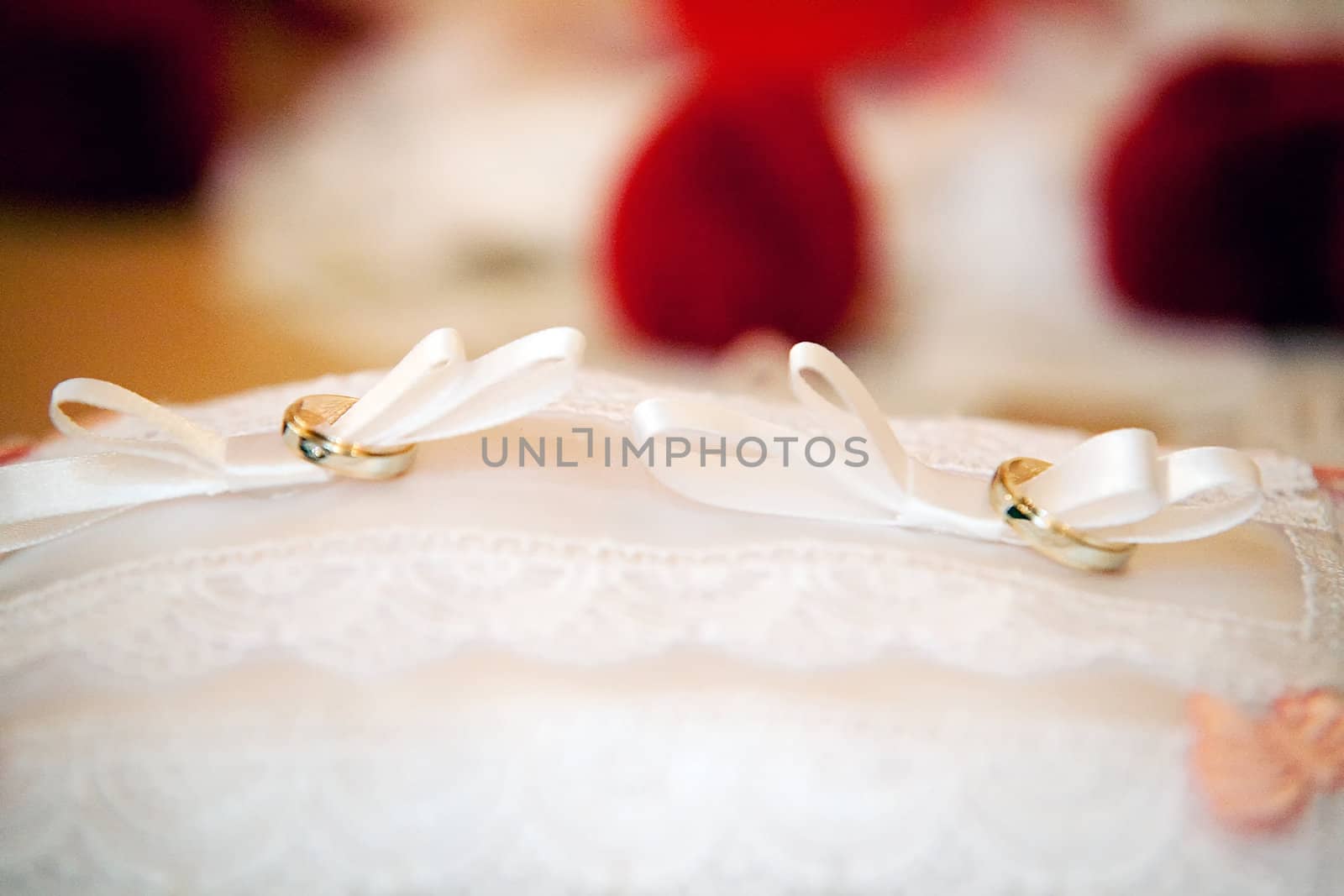 gold wedding rings on the pincushion 