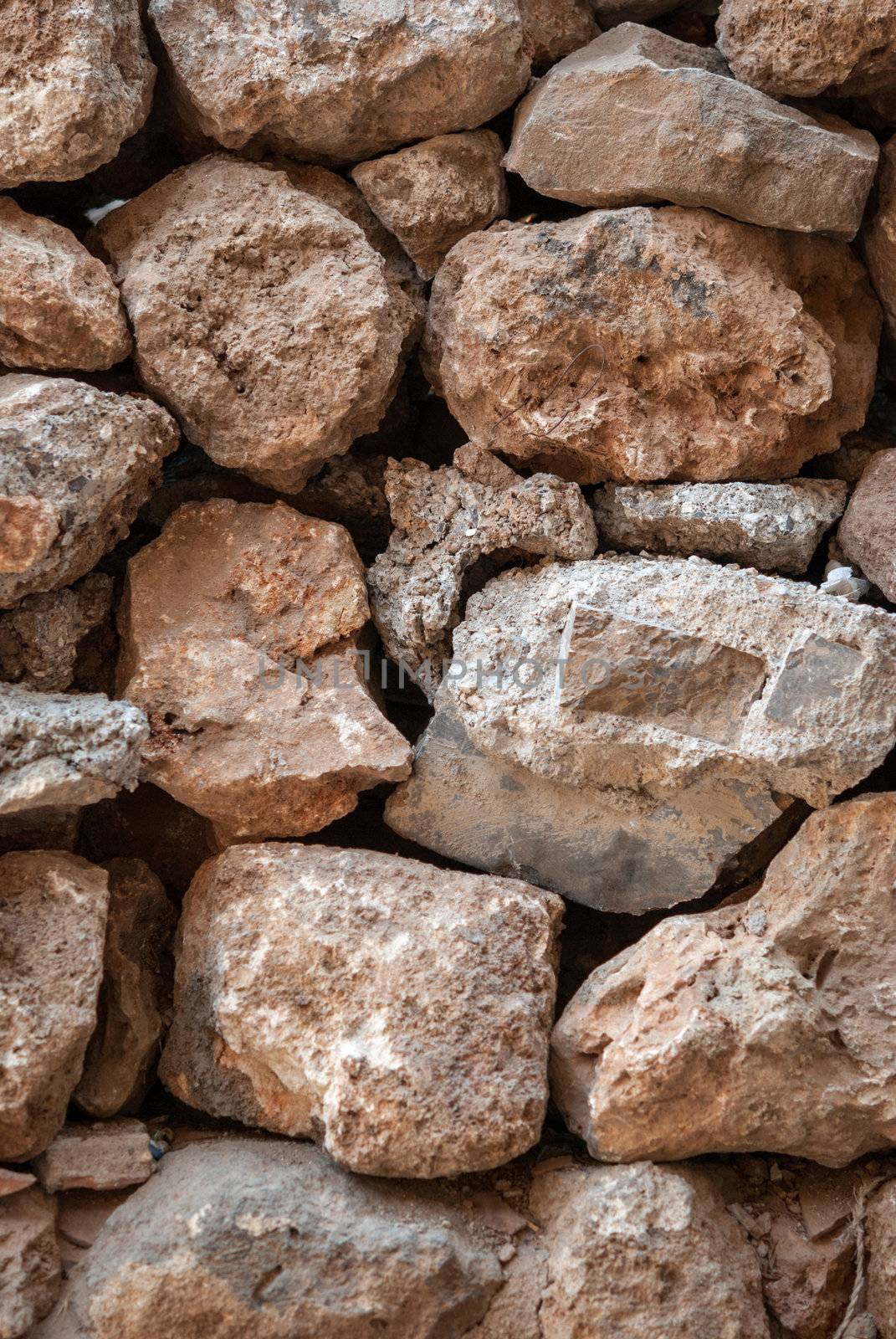 Ancient textured stonework background. Brown tint.