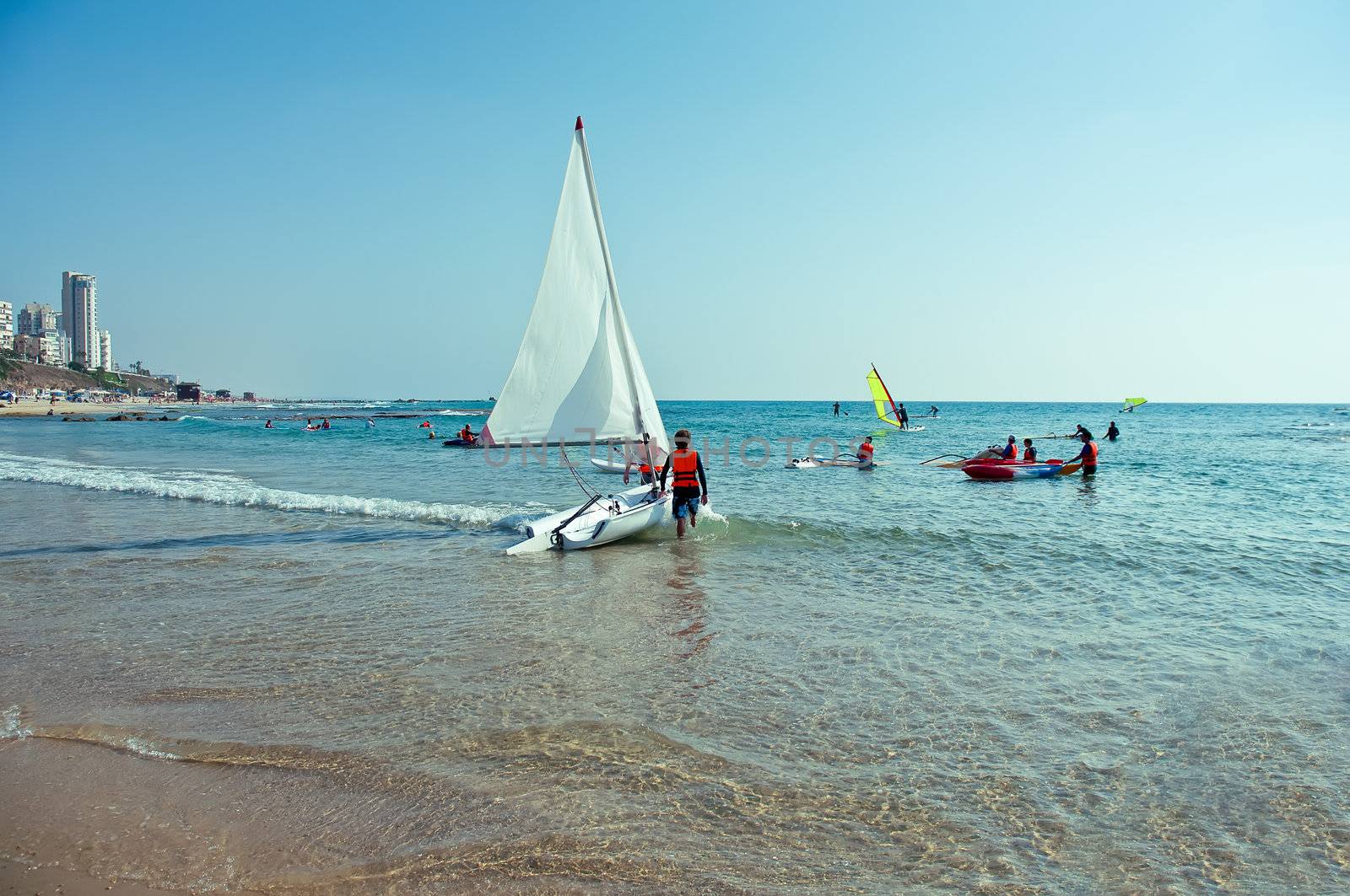 Teenagers learning sailing boat  sailing on the coast of Bat Yam . Israel .
