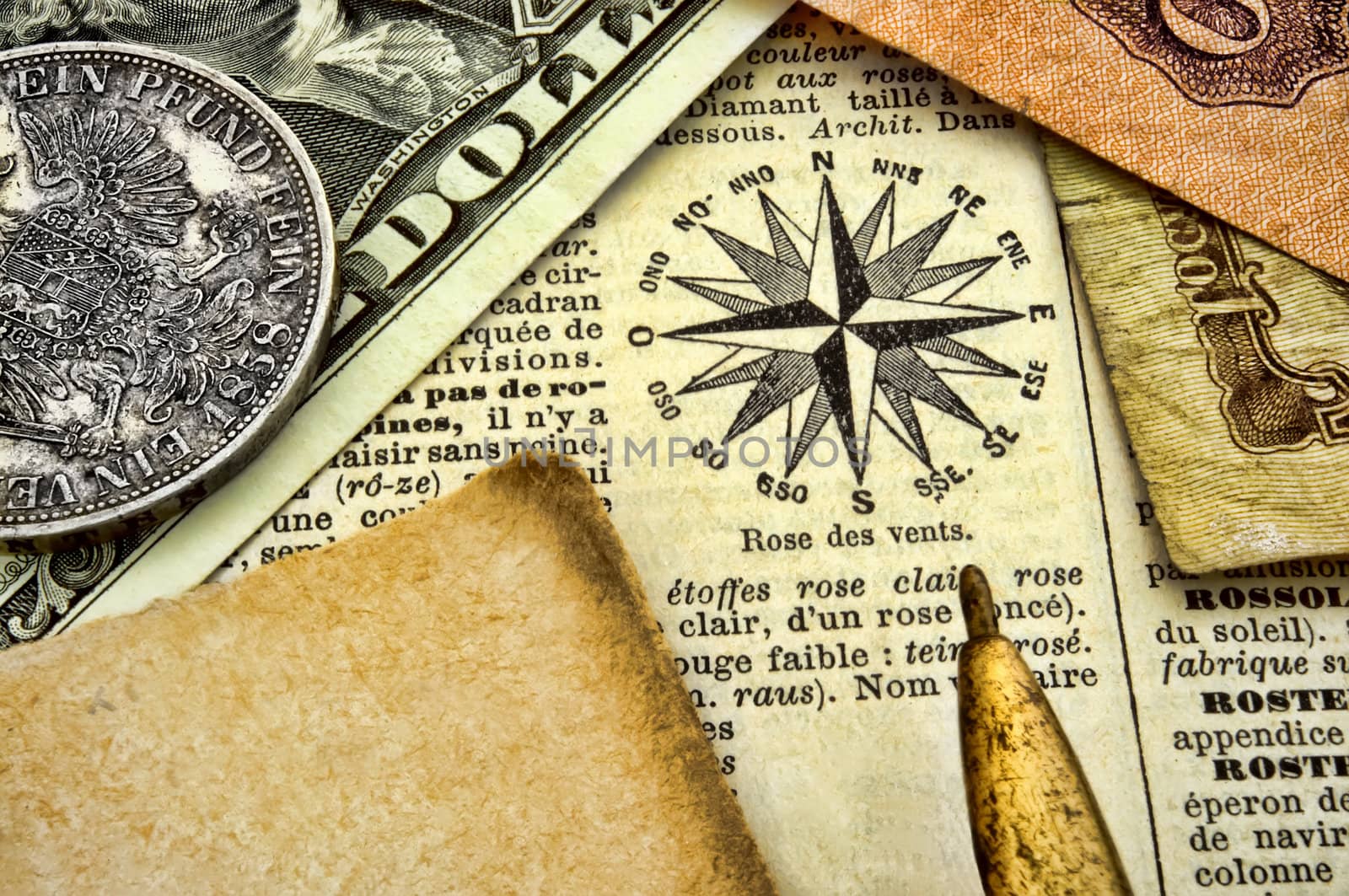 Compass, old documents and money on paper